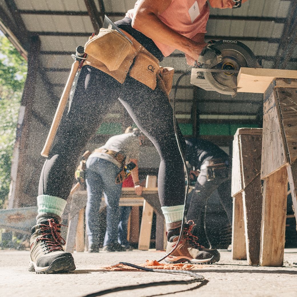 a woman using a circular saw