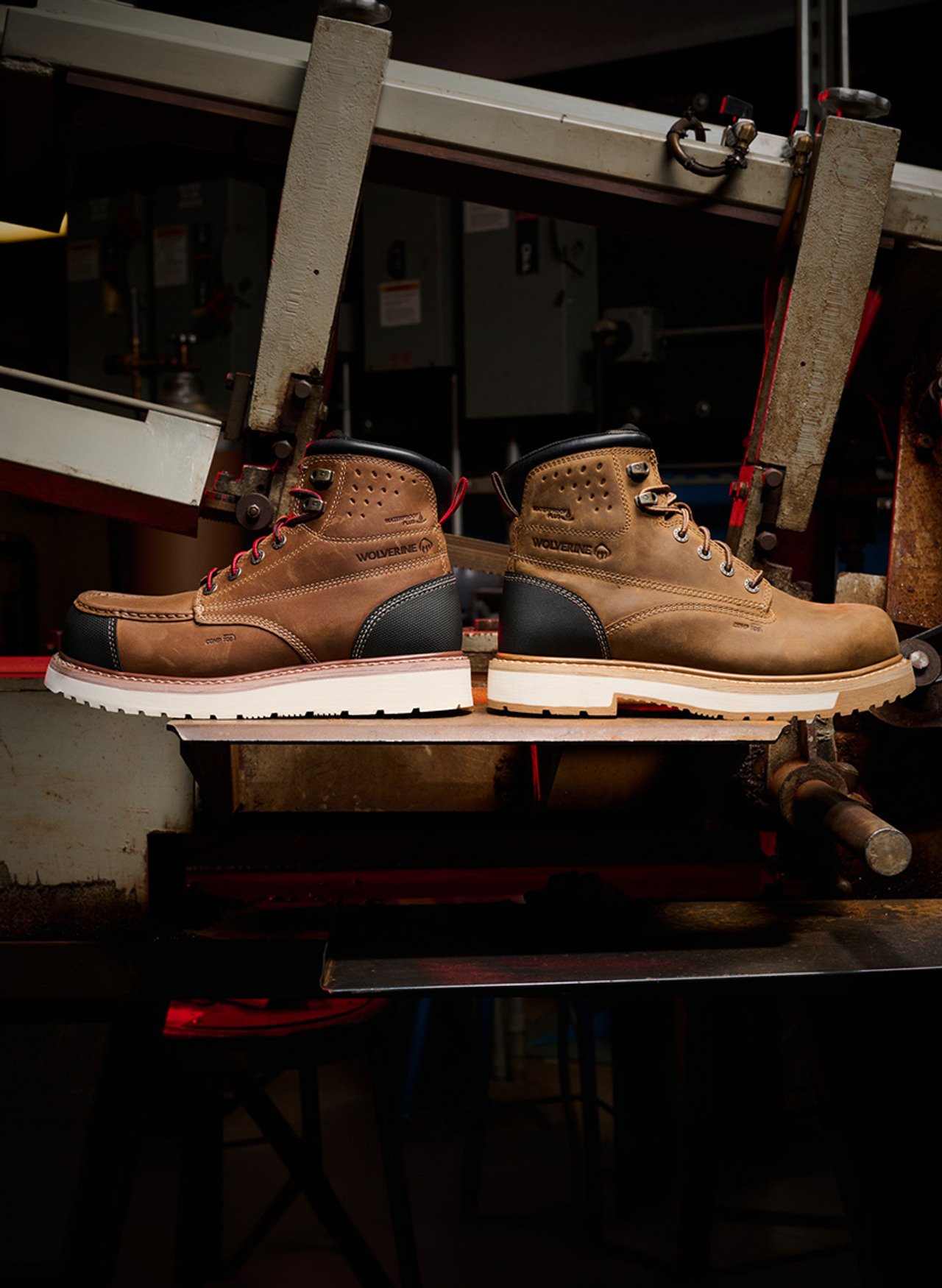 A pair of Wolverine ReLoader work boots on a steel bench in a machine shop.