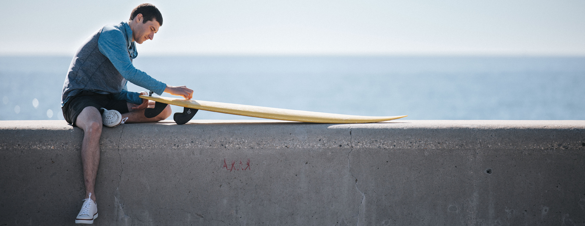 Mikel near the beach prepping his board.