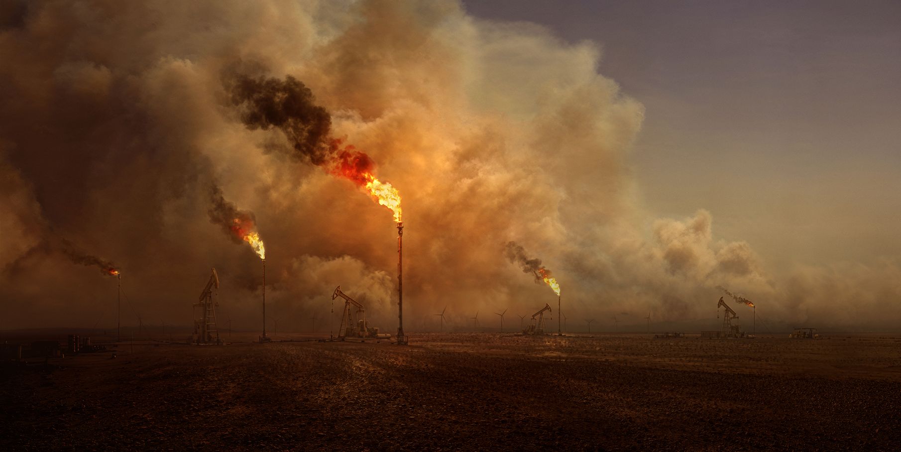 Oil derricks and gas flares.