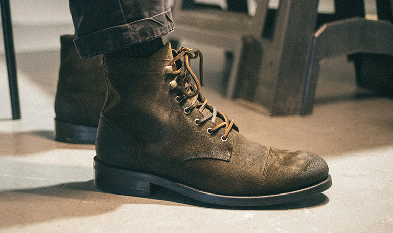 Wolverine BLVD Cap Toe in black on a barber's chair being tied.