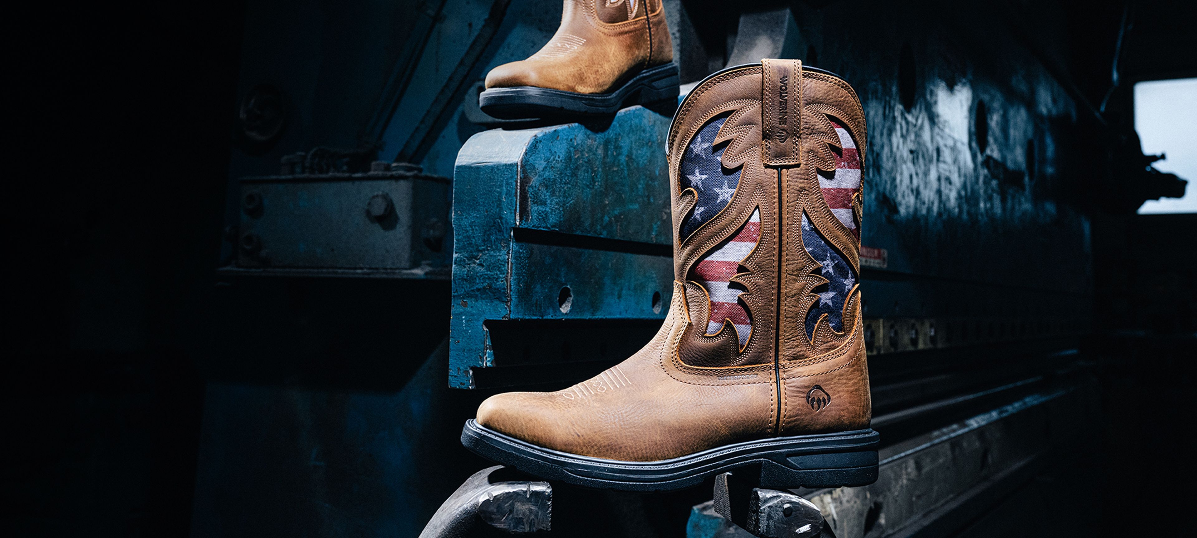 Boots pushing down on a metal footbrake.