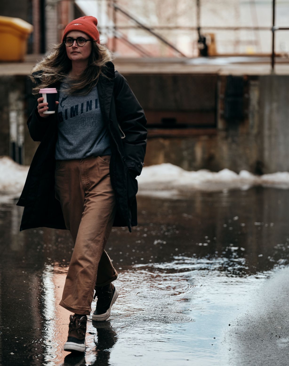 Person walking in the rain wearing Wolverine boots.