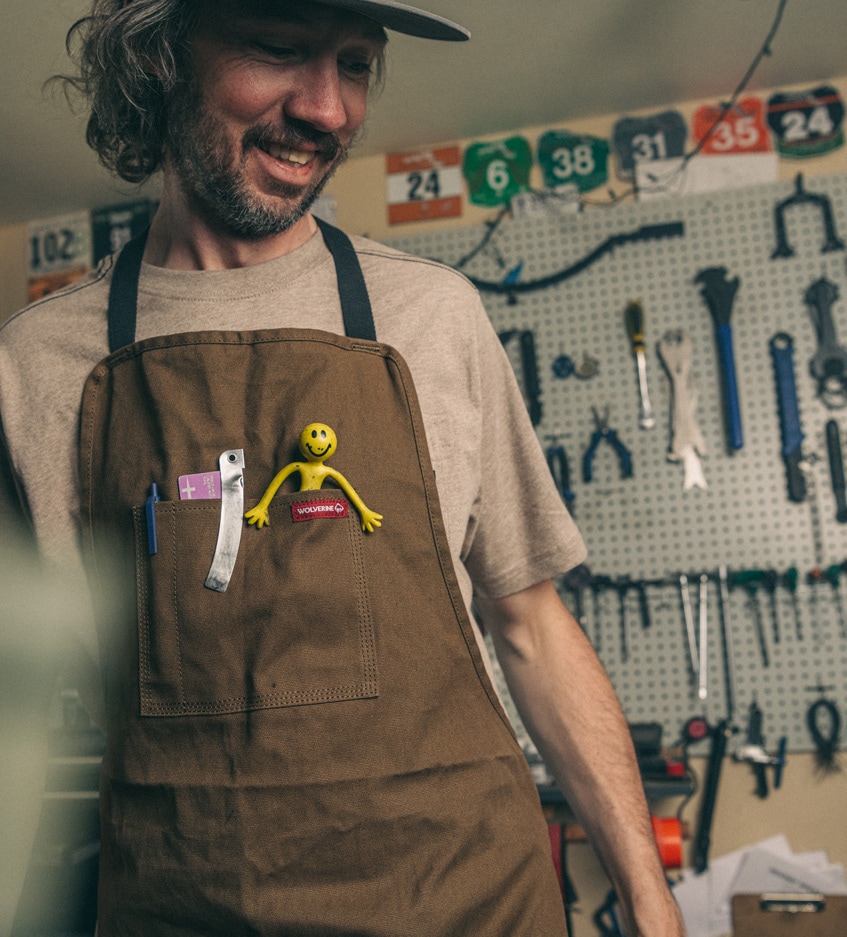 Nathan Miller smiling in a bike shop.