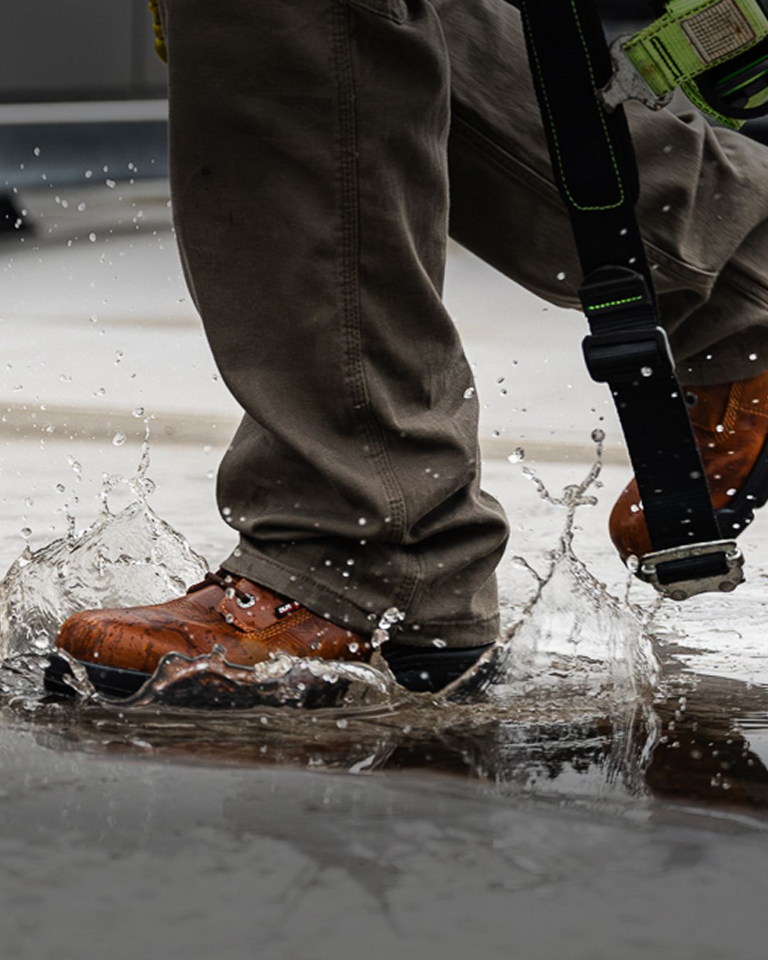 Brown boots splashing through puddles.