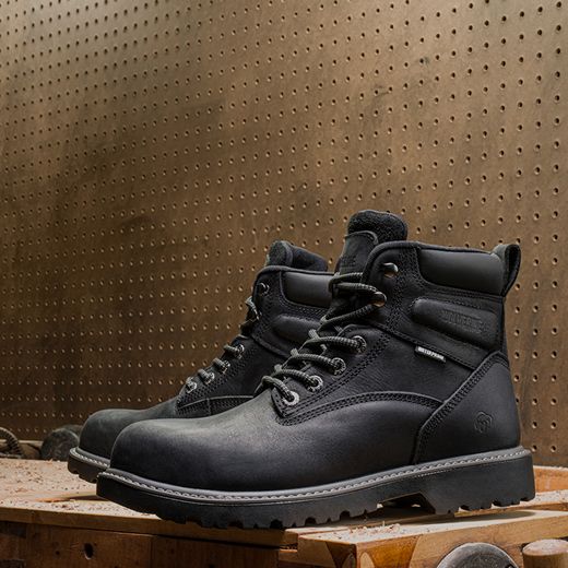 Black boots on a workbench.