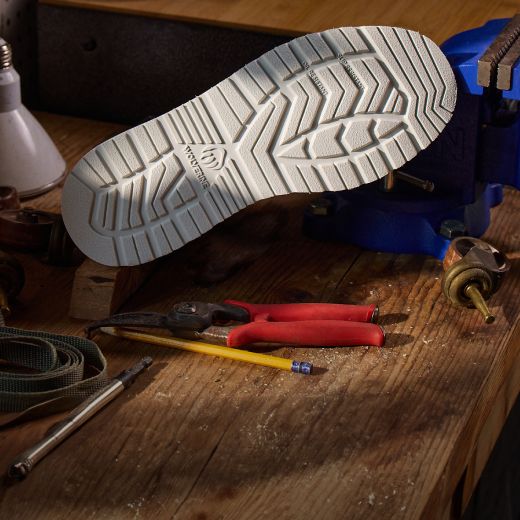Boot, sole up on a workbench.