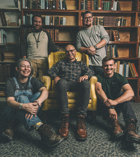 Markus and some of his apprentices sitting by him in his favorite chair in front of that bookshelf again.