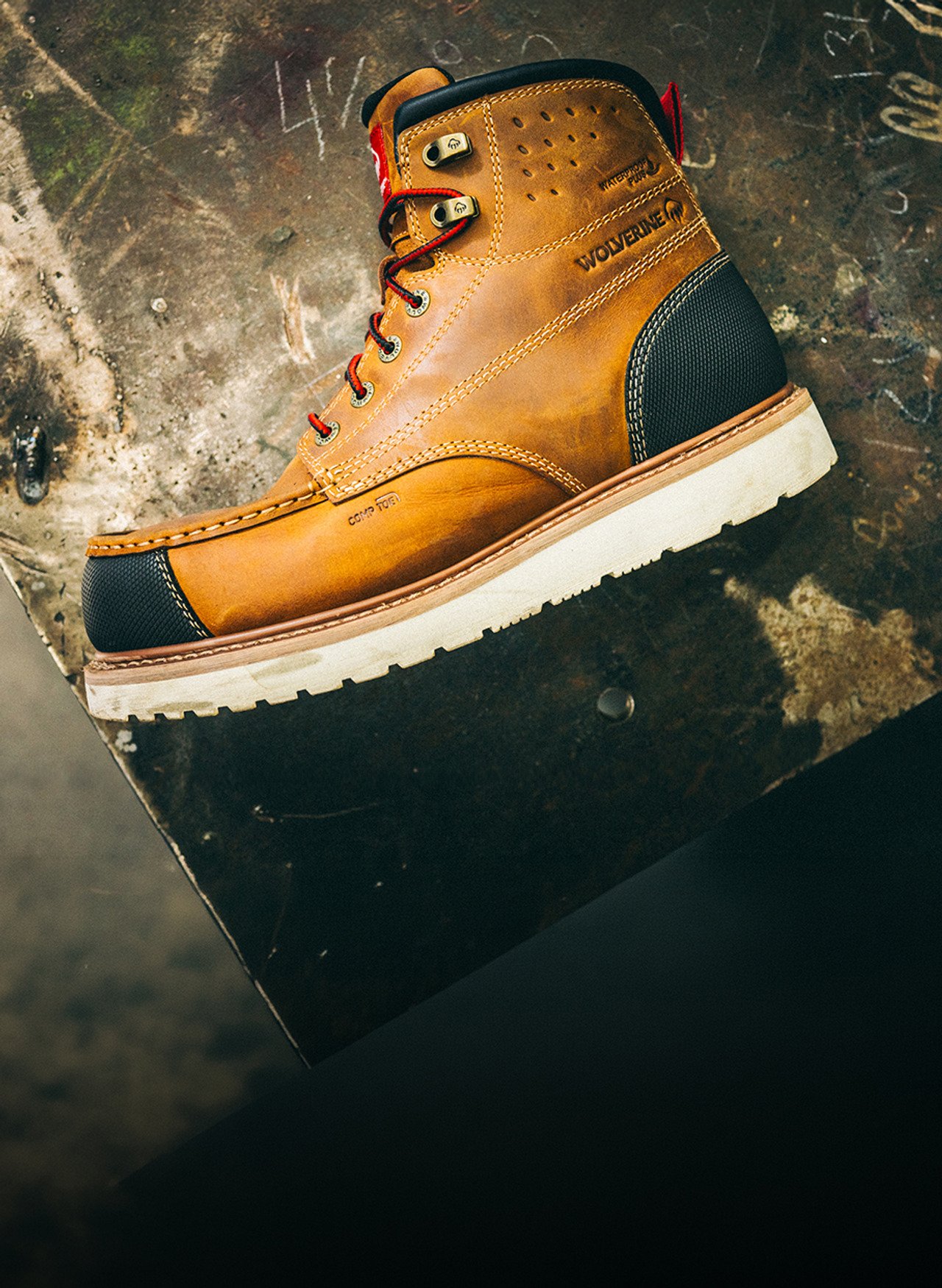 A Wolverine ReLoader wedge sole boot standing on a scuffed steel plate.