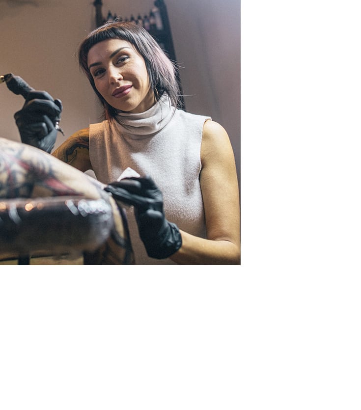 Erin C. working on a Tattoo
