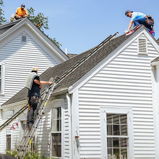 Workers on ladders and roofs.