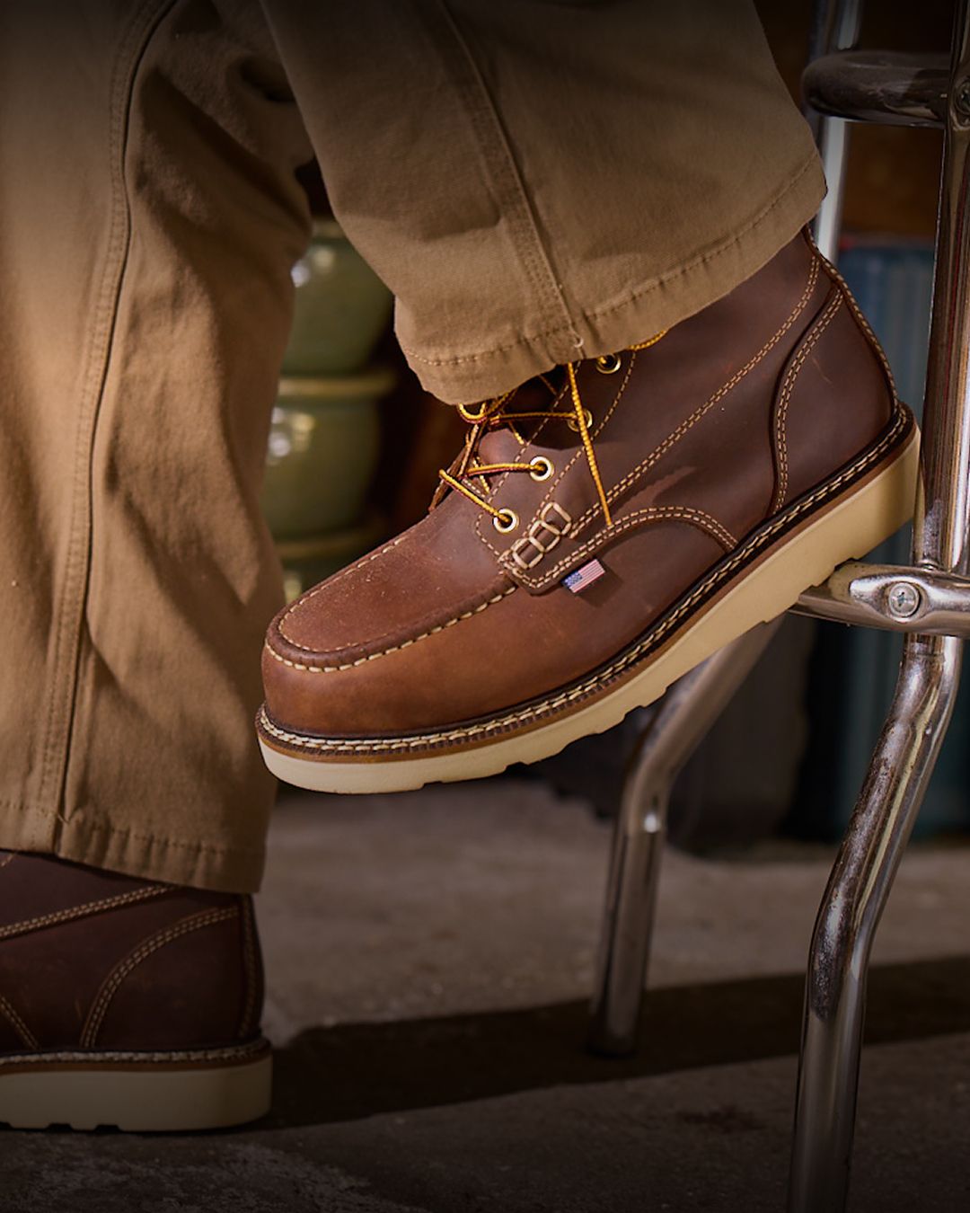 Brown boots on a stool.