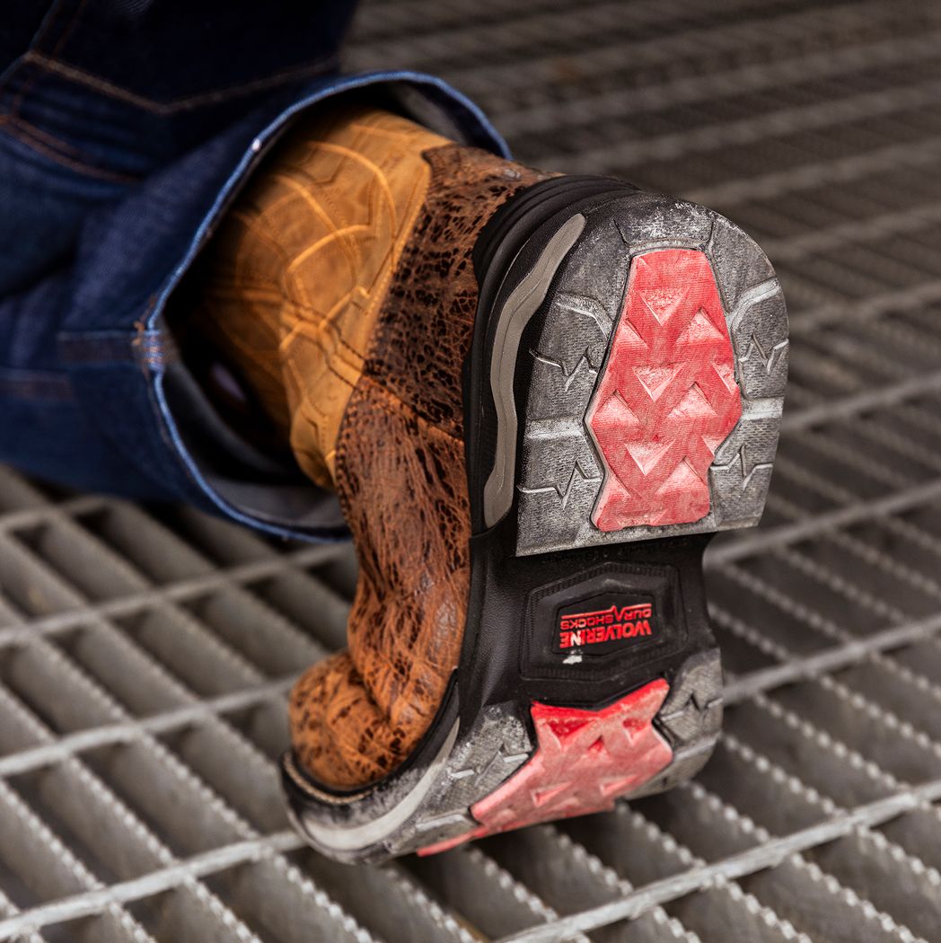 Boot on a bollard, showing the black and red Infinity System sole.
