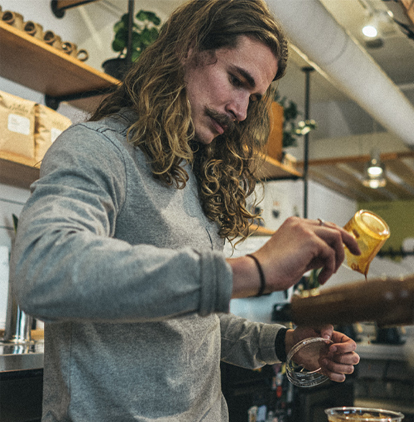 Caleb Donhowe crafting a coffee.