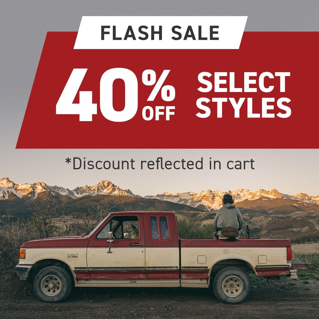 a man sitting on a pickup truck