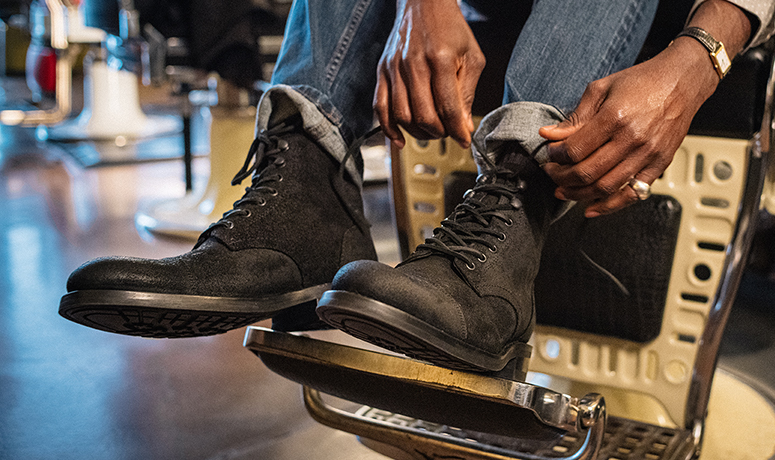 Wolverine BLVD Cap Toe in black on a barber's chair being tied.