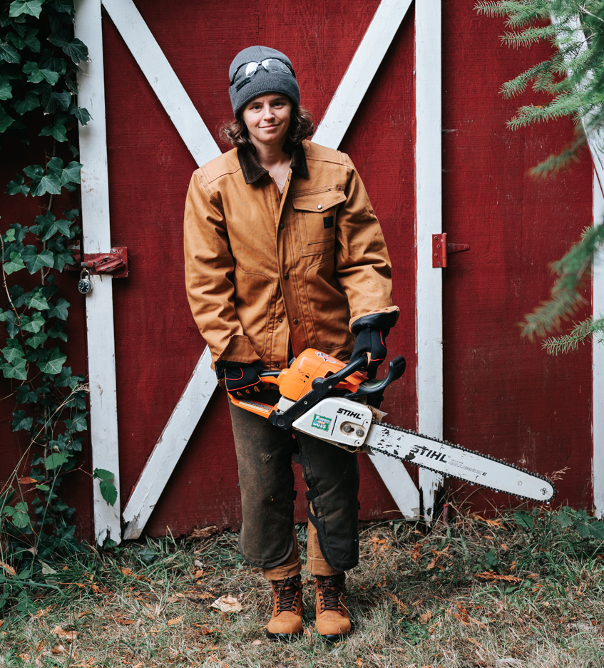 Amanda holding a chainsaw