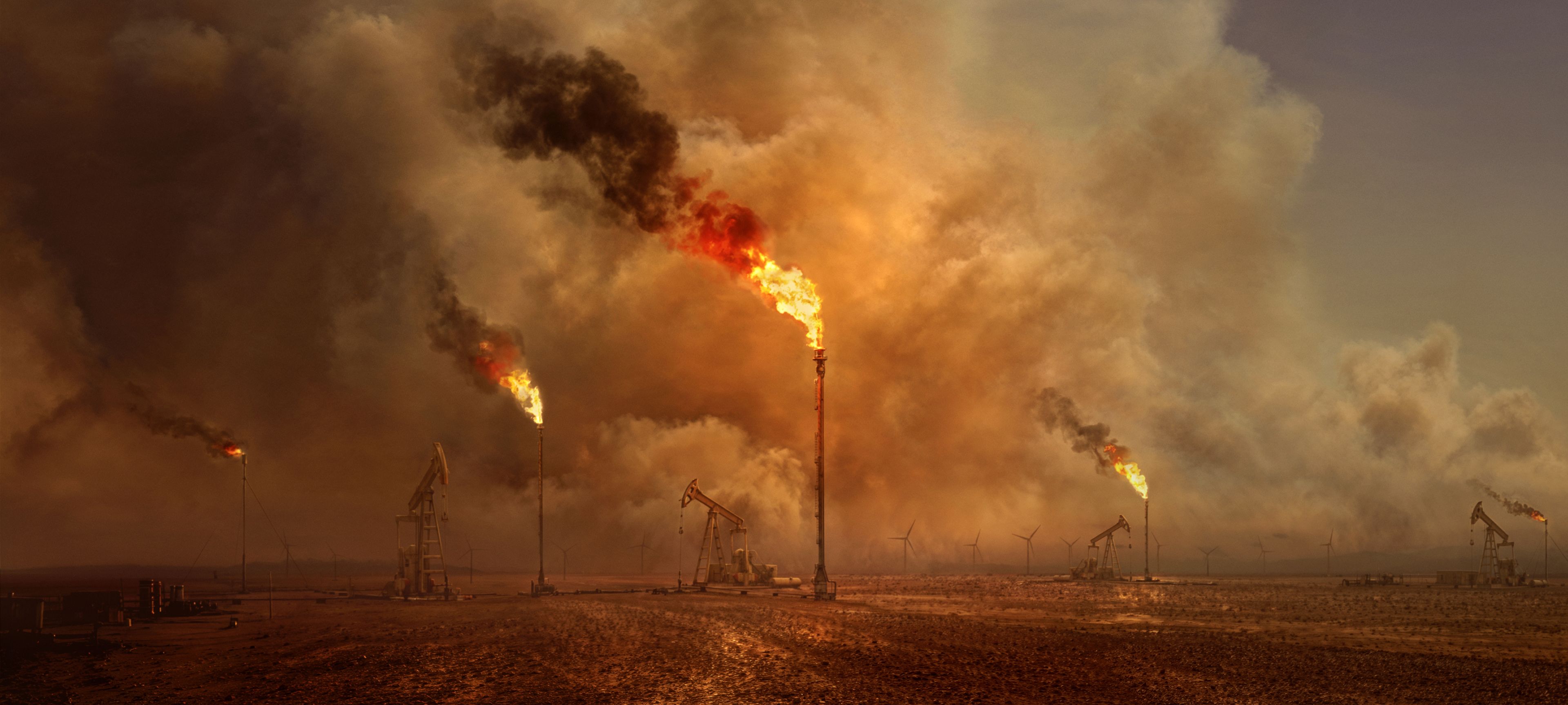 Oil derricks and gas flares.