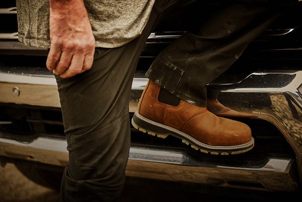 Boot on the bumper of a truck.