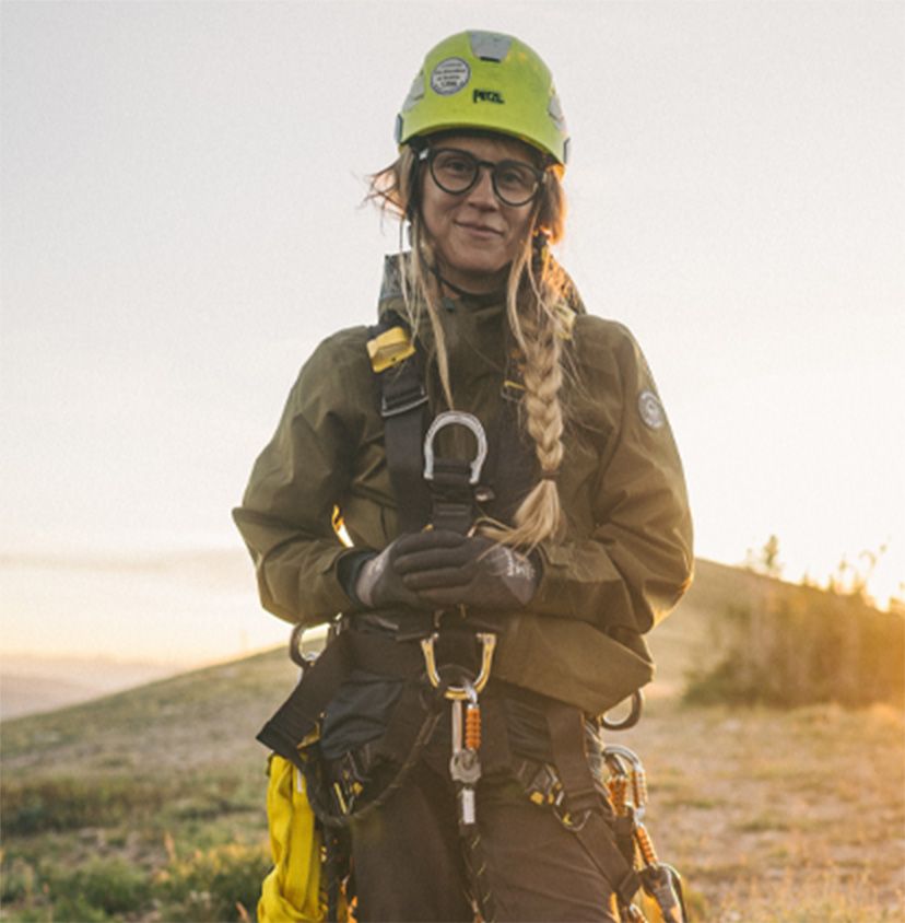 a woman wearing a helmet and harness