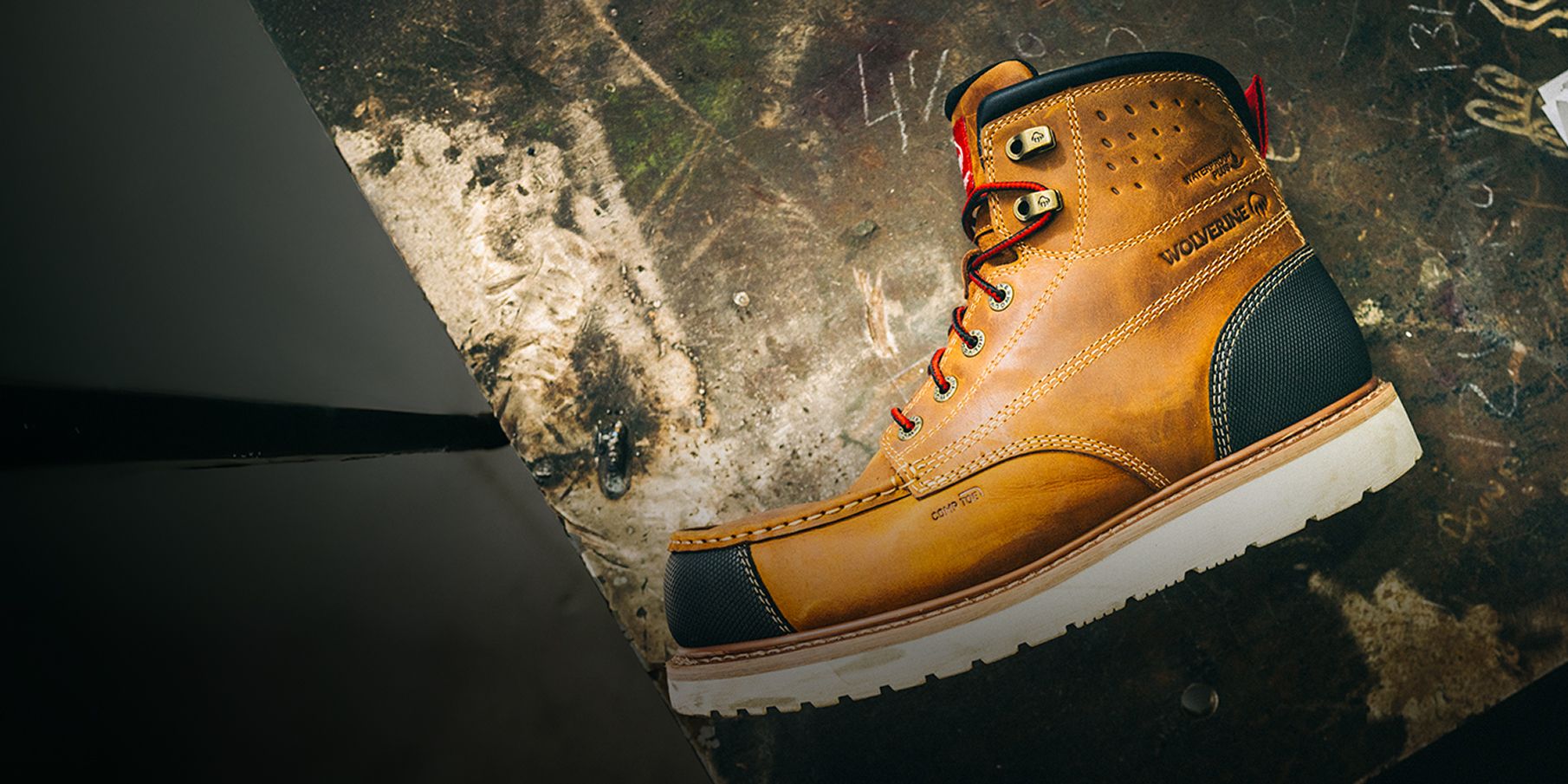 Side view of a black, brown, and white boot.