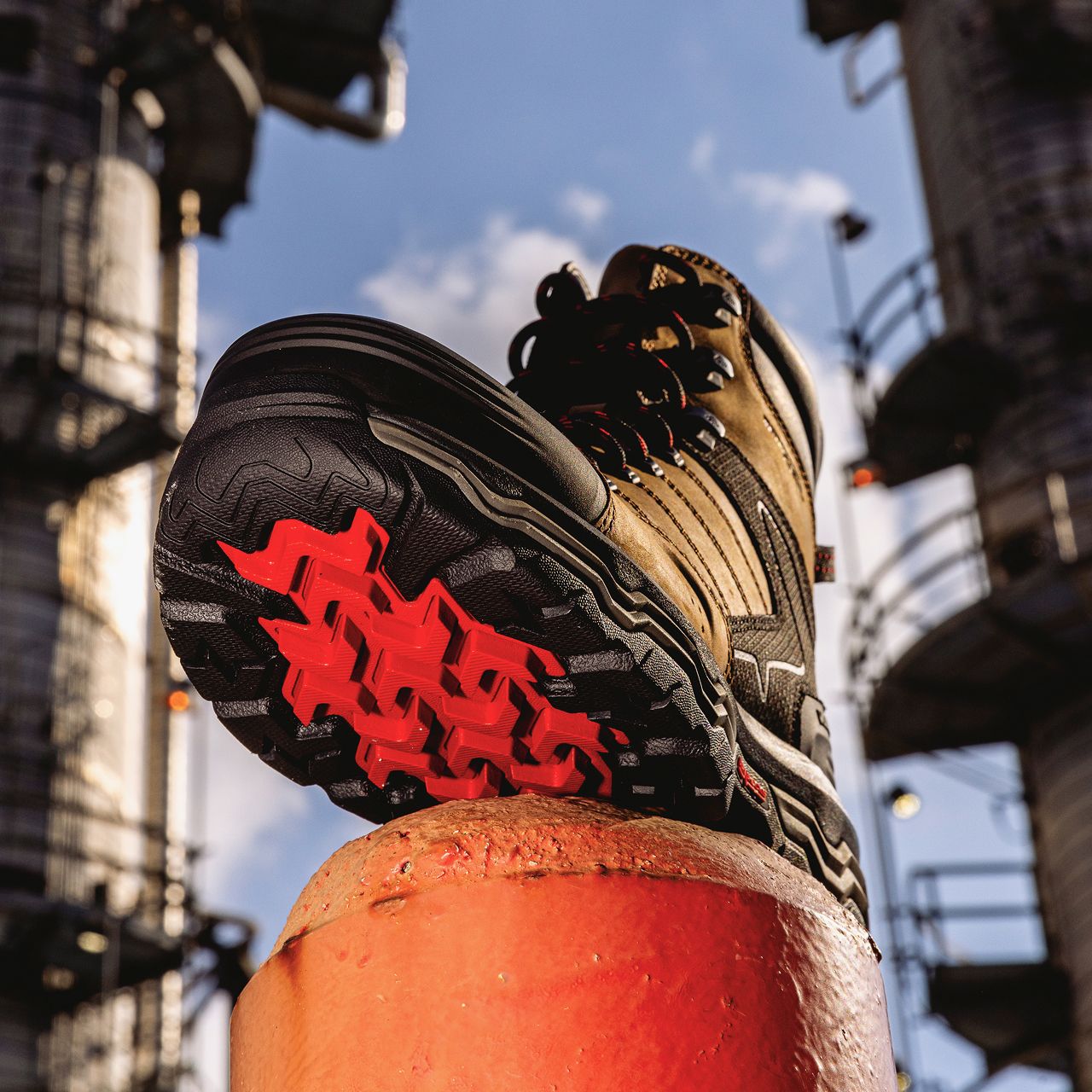 Boot on a bollard, showing the black and red Infinity System sole.