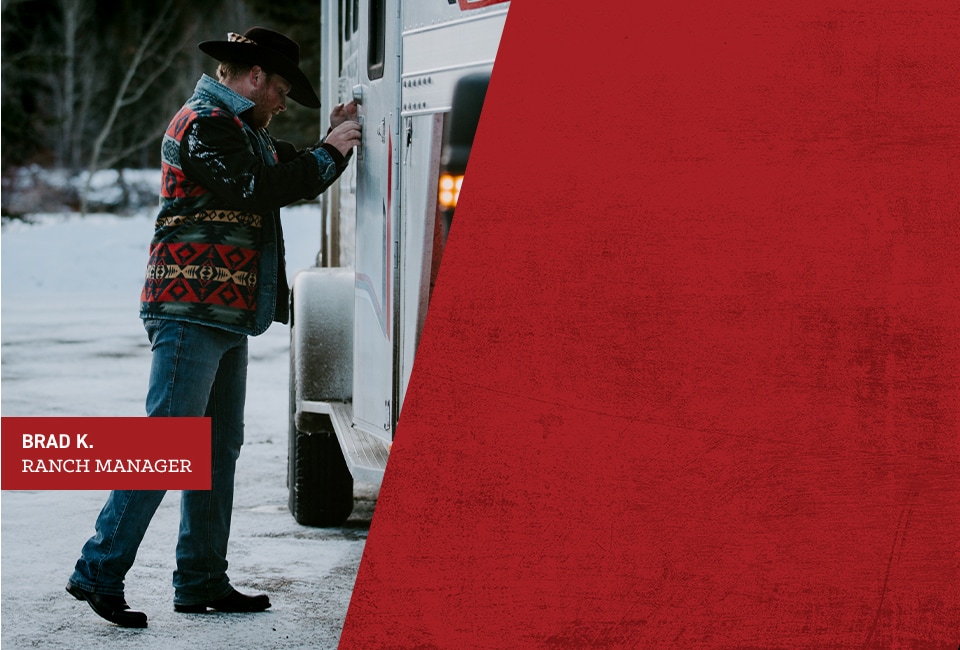 Brad K., Ranch Manager. Brad is closing the door of a horse trailer.