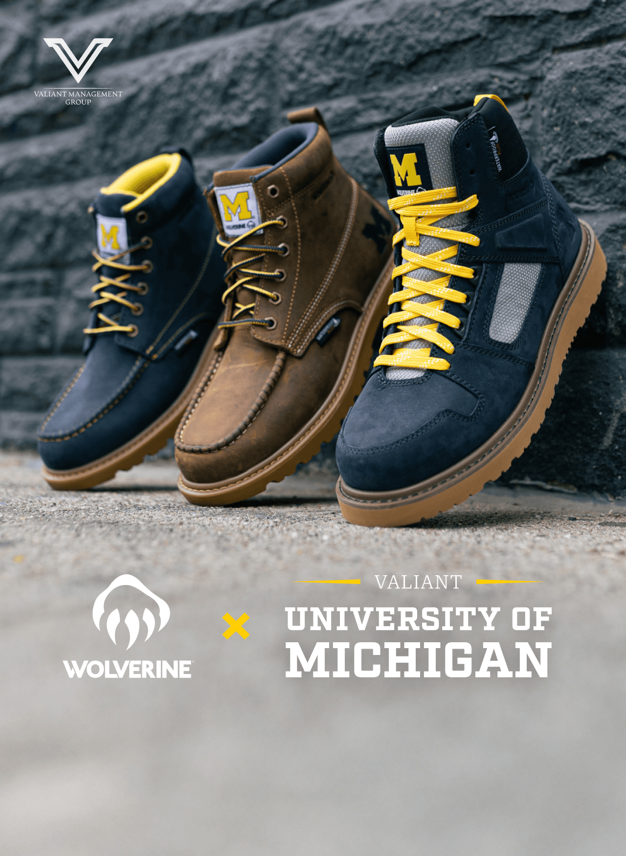 Three variants of the Wolverine x Valiant Management Group University of Michigan boots leaning against a wall; two in maize and blue, and one tan with maize and blue laces.
