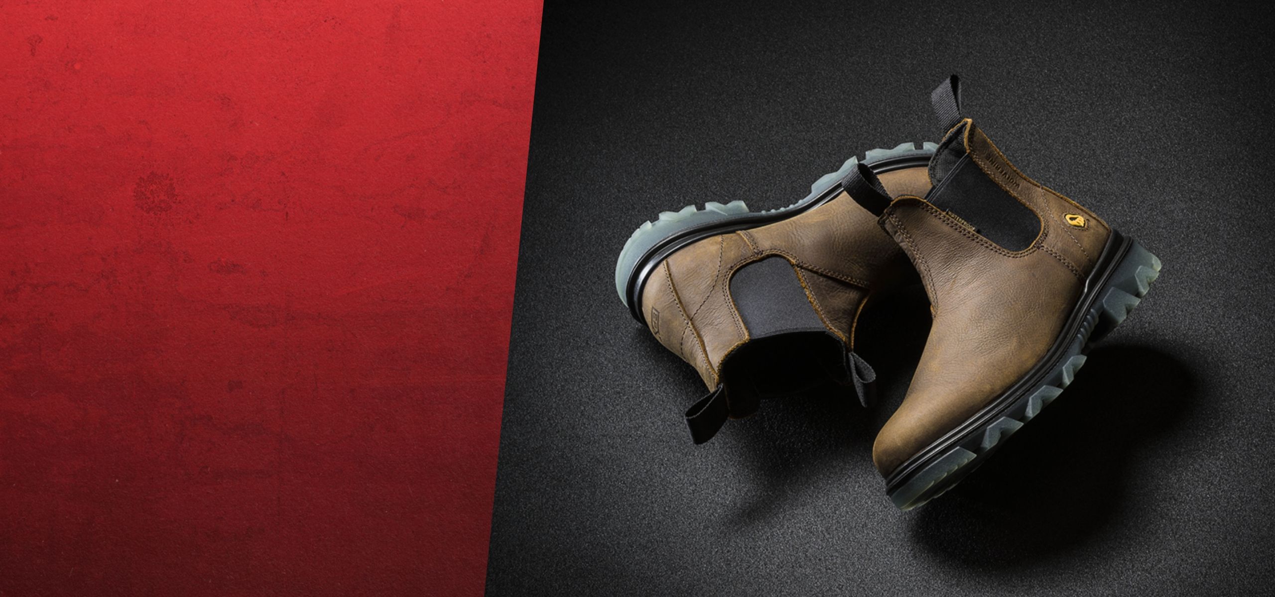 a pair of brown boots on a black and red surface