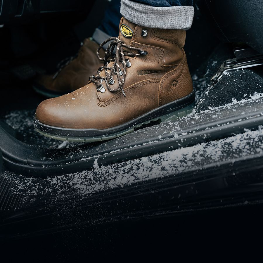 Two boots on a workbench.