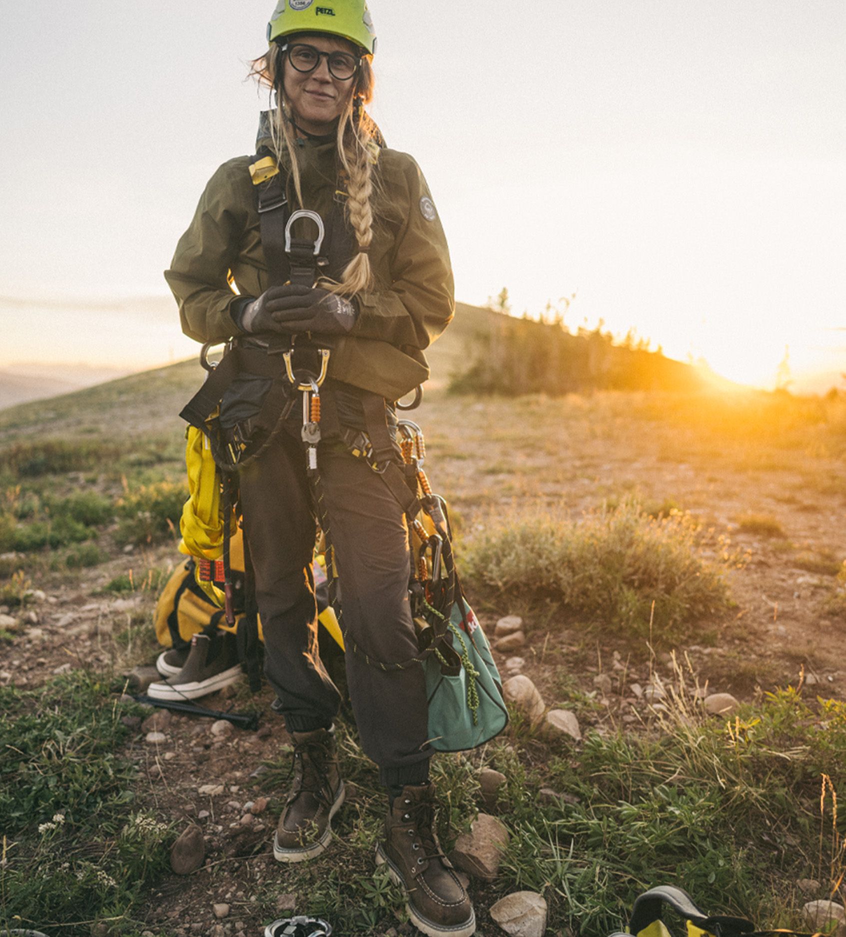 a woman wearing a helmet and harness