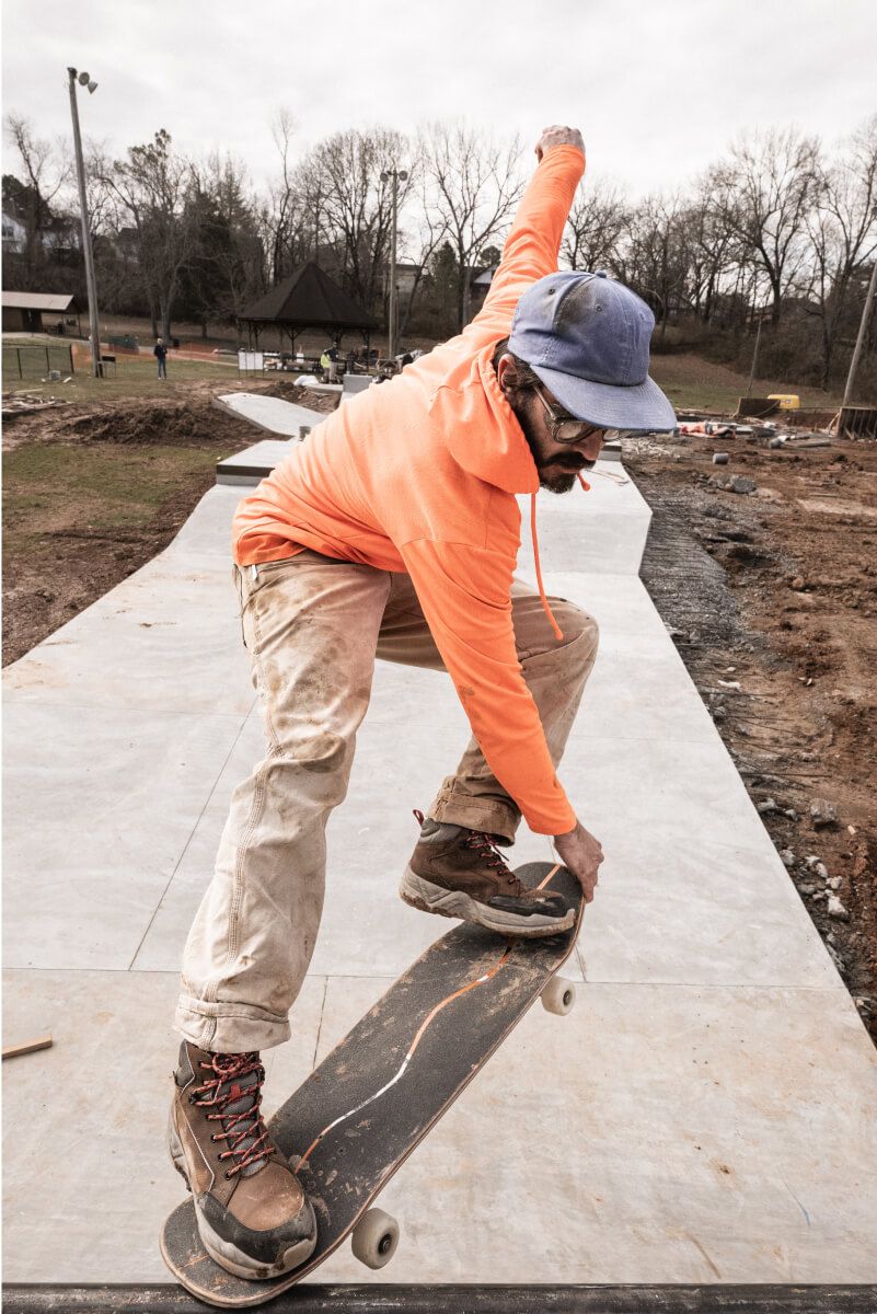 a person wearing construction clothes skateboarding