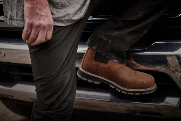 Brown boot climbing into a truck