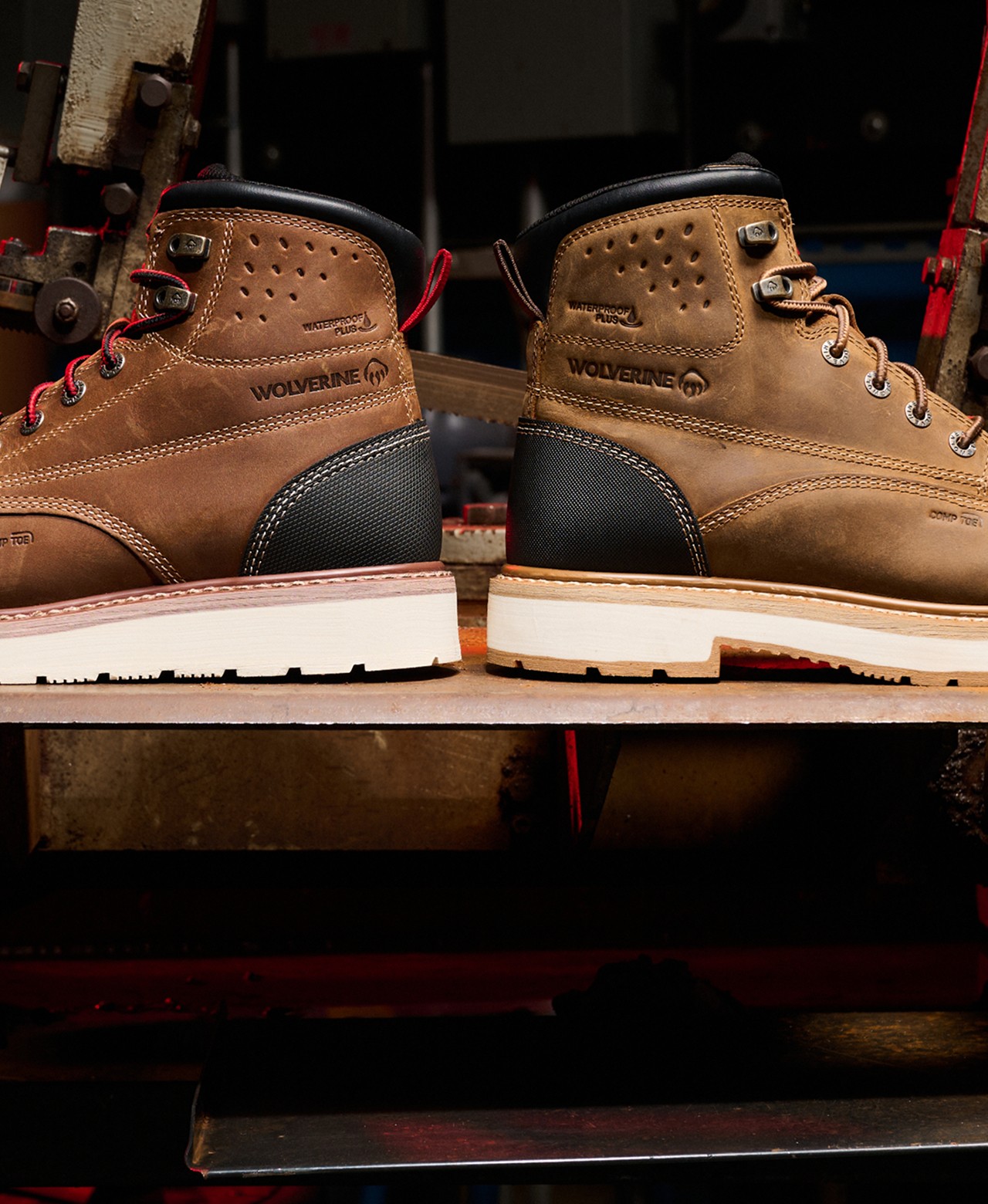 A pair of brown Loader work boots on a workshop shelf.