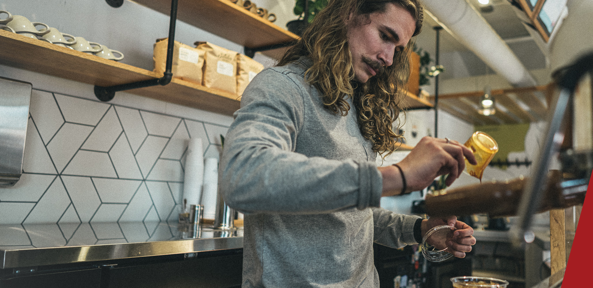 Caleb Donhowe crafting a coffee.