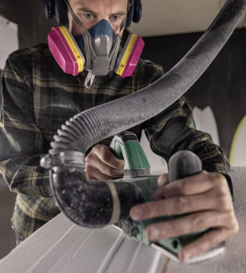 Mikel sanding down a board to perfection.