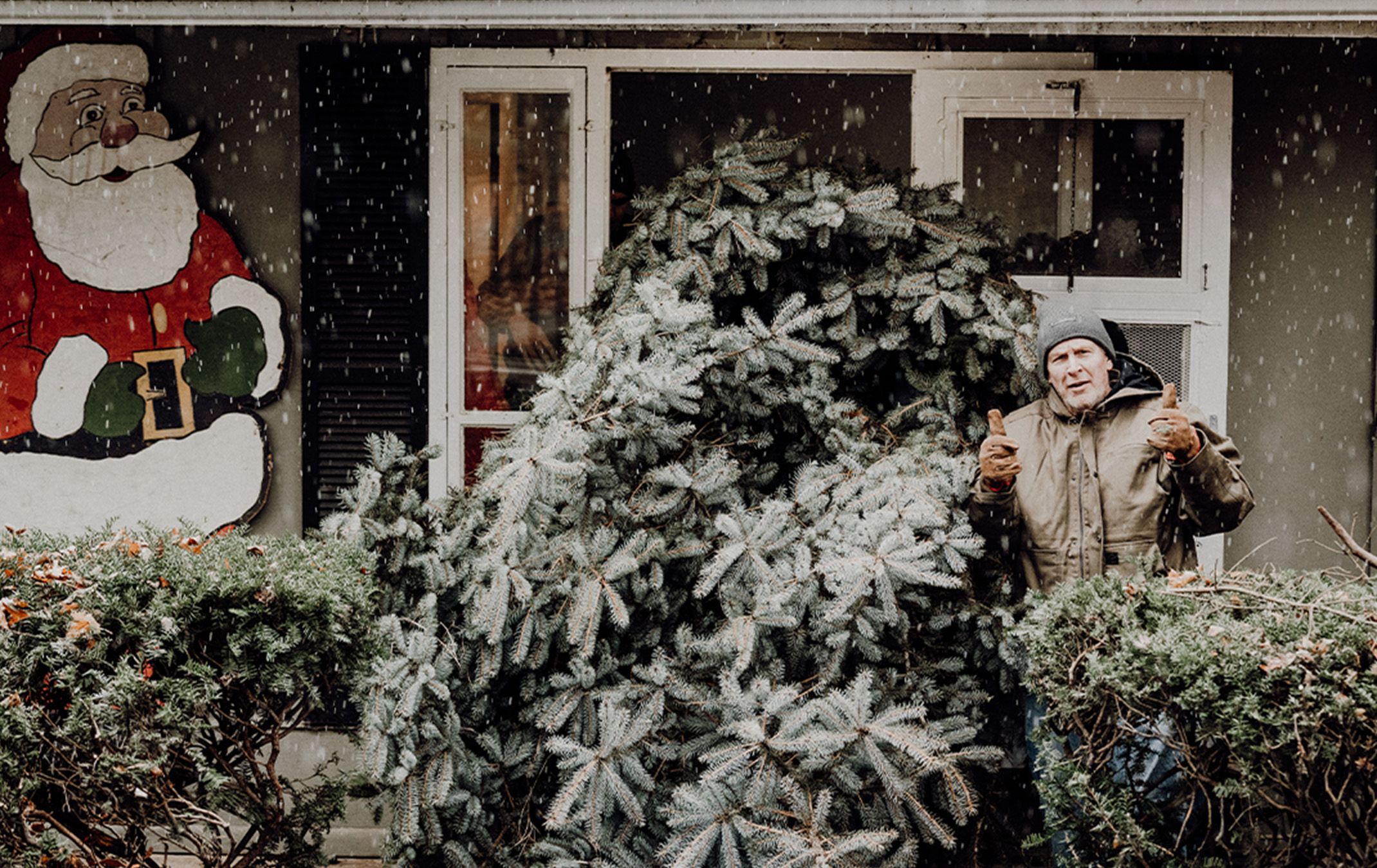 a man standing next to a tree