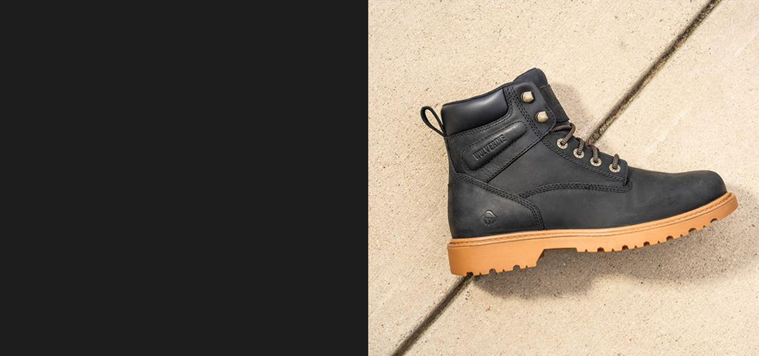 Black boot lying on concrete.