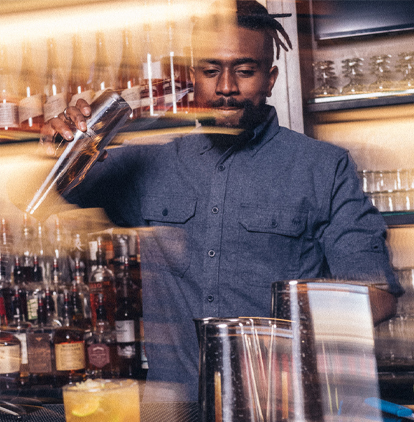 Chase Bardole mixing drinks behind his bar.