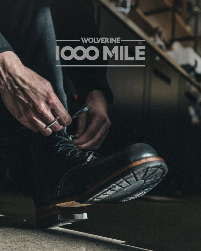 Tying the laces on a black leather boot.