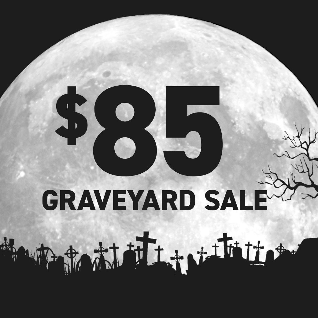 a large moon with a cemetery and a tree