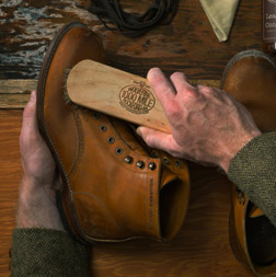 Man brushing leather boot