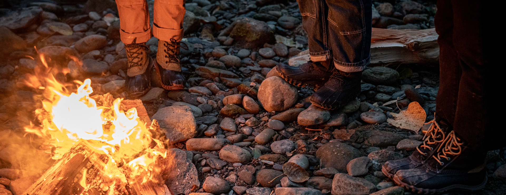 Amanda and friends standing next to a fire