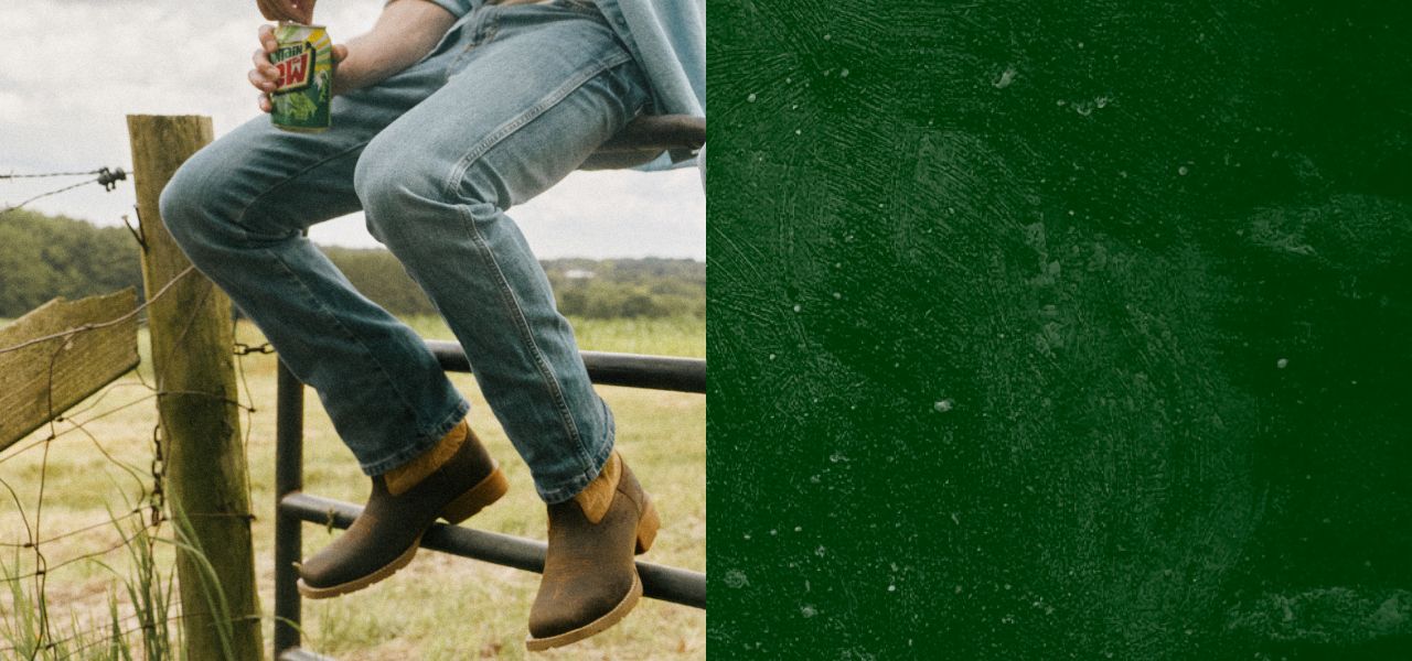 Sitting on a metal gate wearing brown boots.