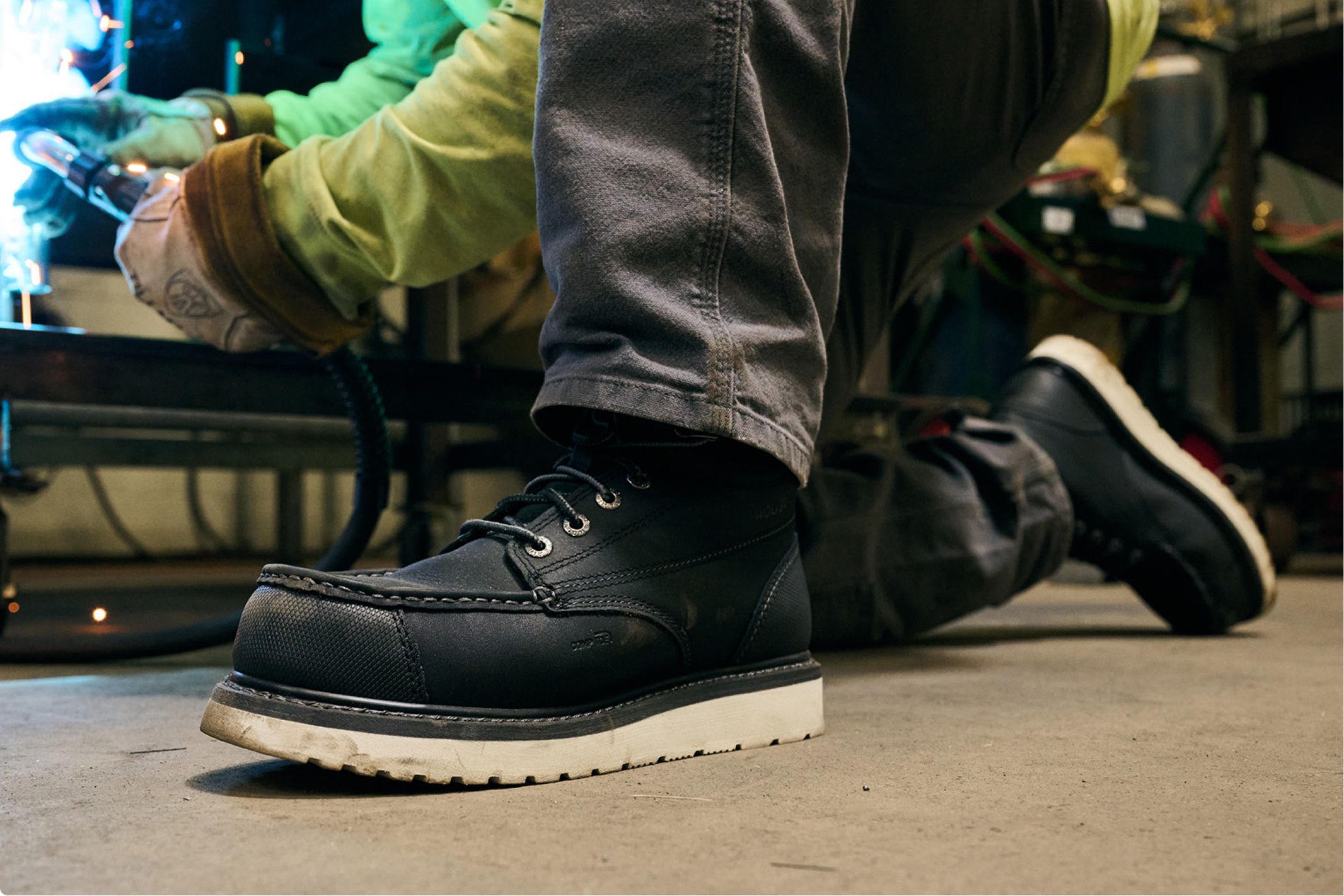 An electrician wearing black boots.