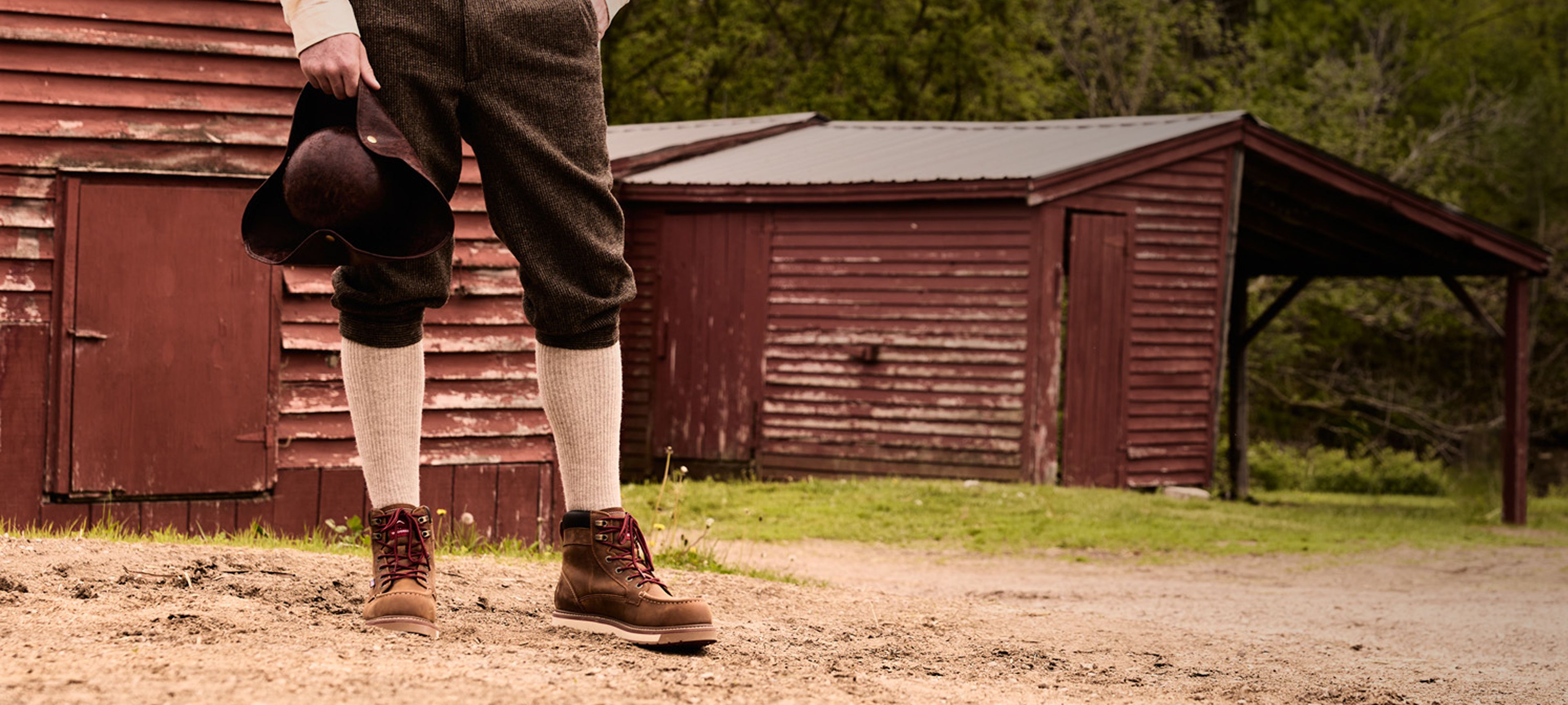 Minuteman's legs standing in front of a historic building wearing USA-Built boots.