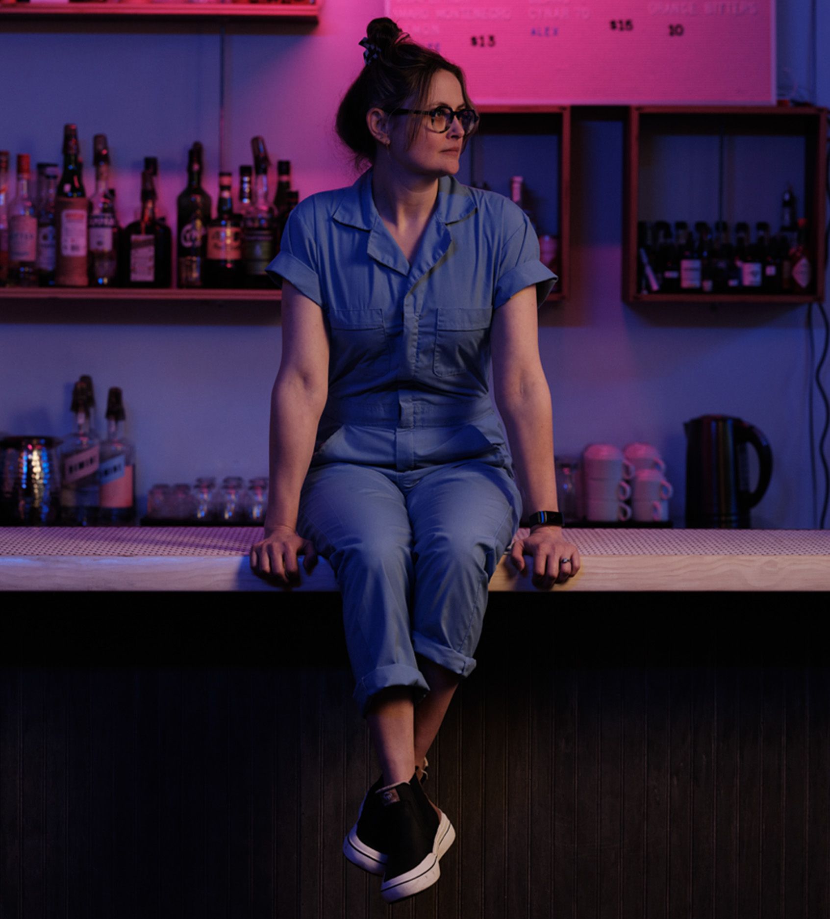 a woman sitting on a bar