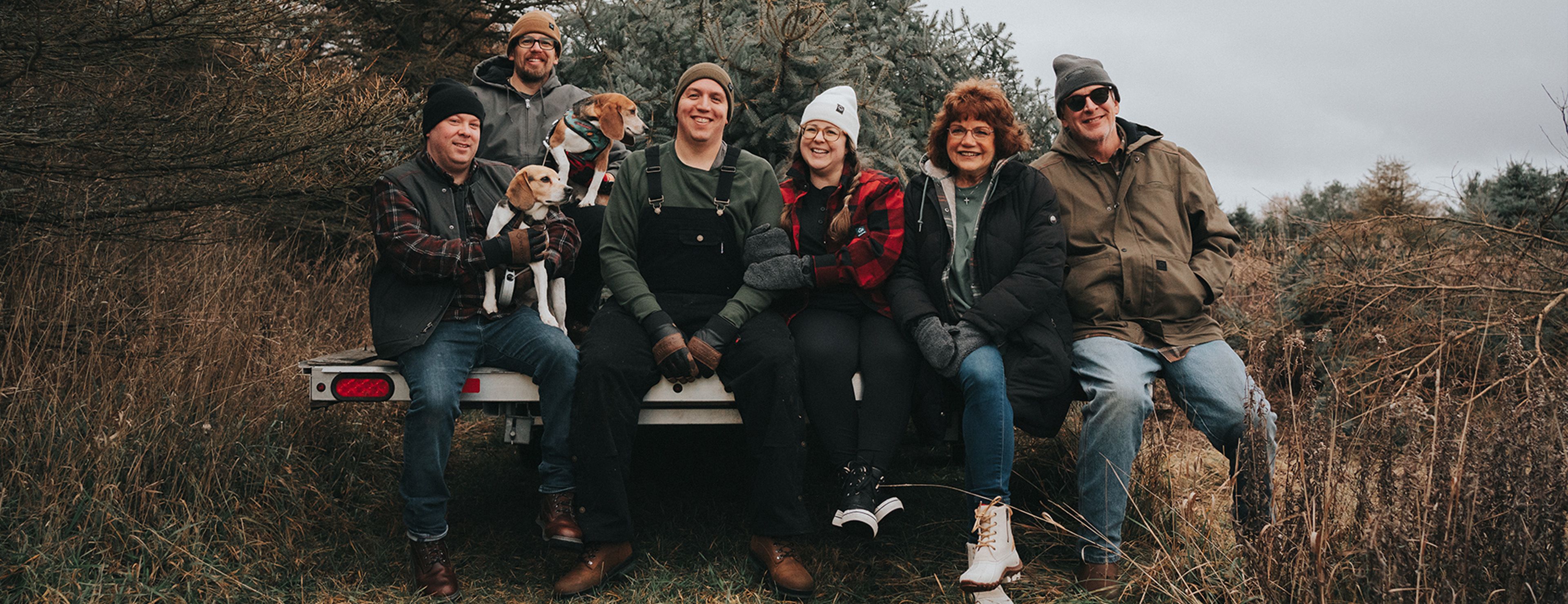 a group of people and a dog posing for a photo