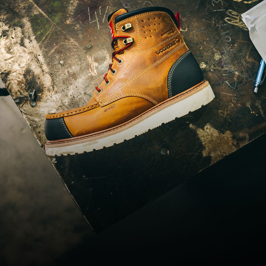 Side view of a black, brown, and white boot.