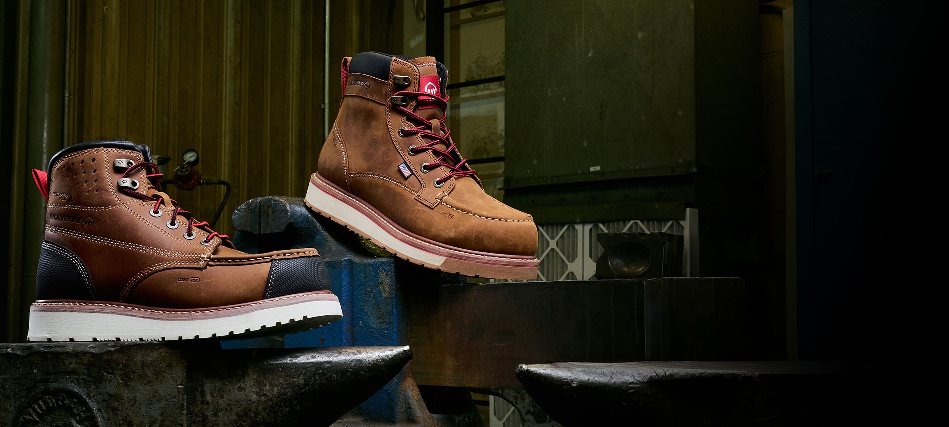 Boots standing on a heavy metal vice and an anvil.